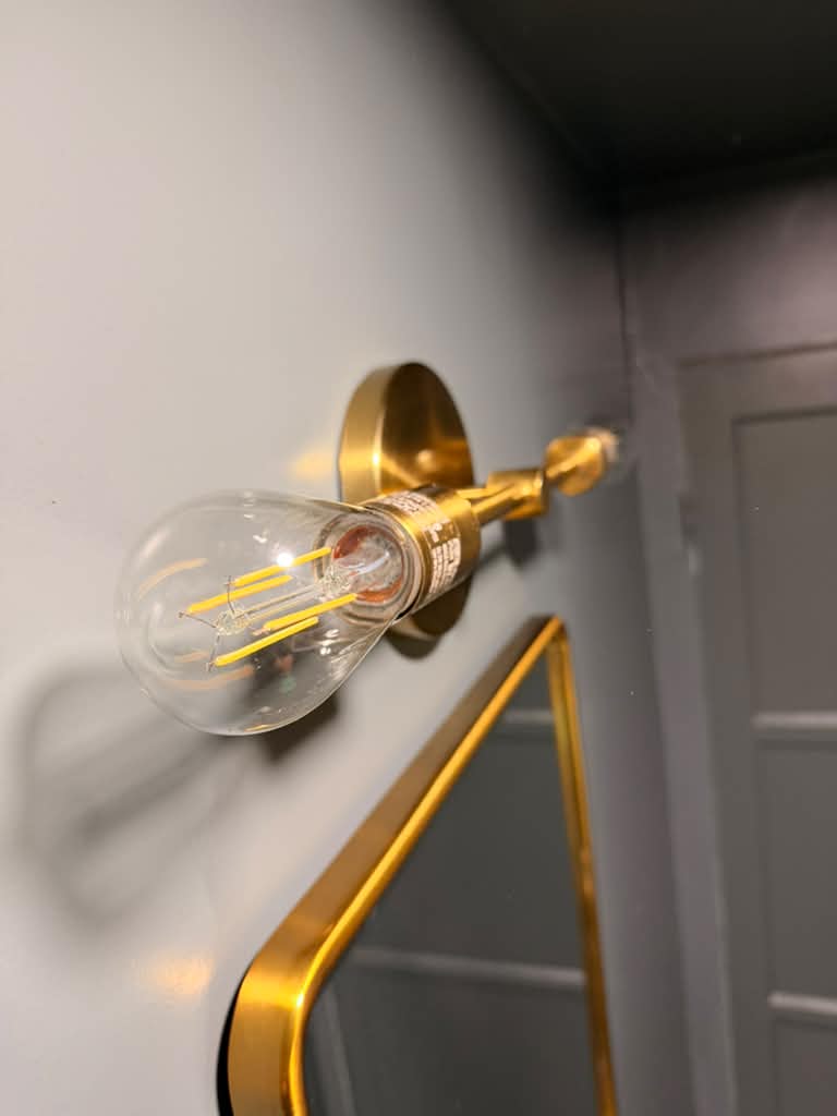 Polished gold wall light after detail cleaning