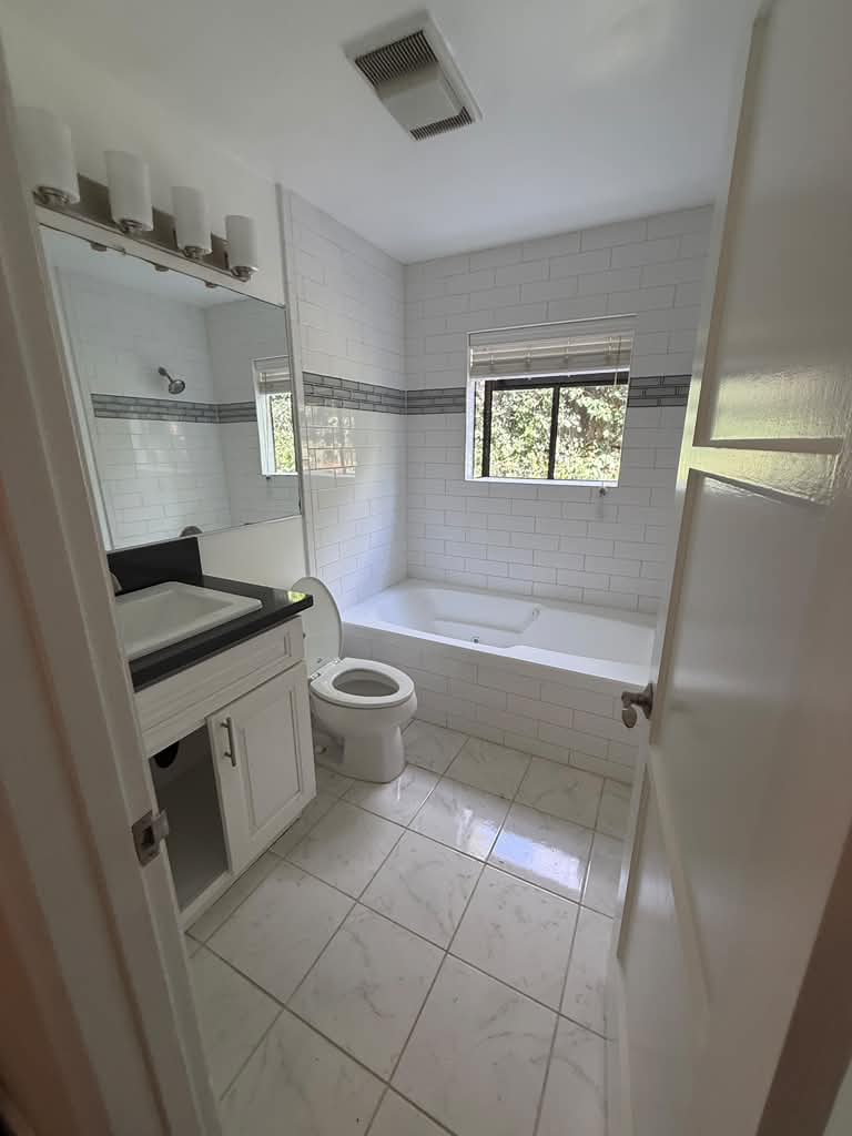 Bright tiled bathroom cleaned after renovation