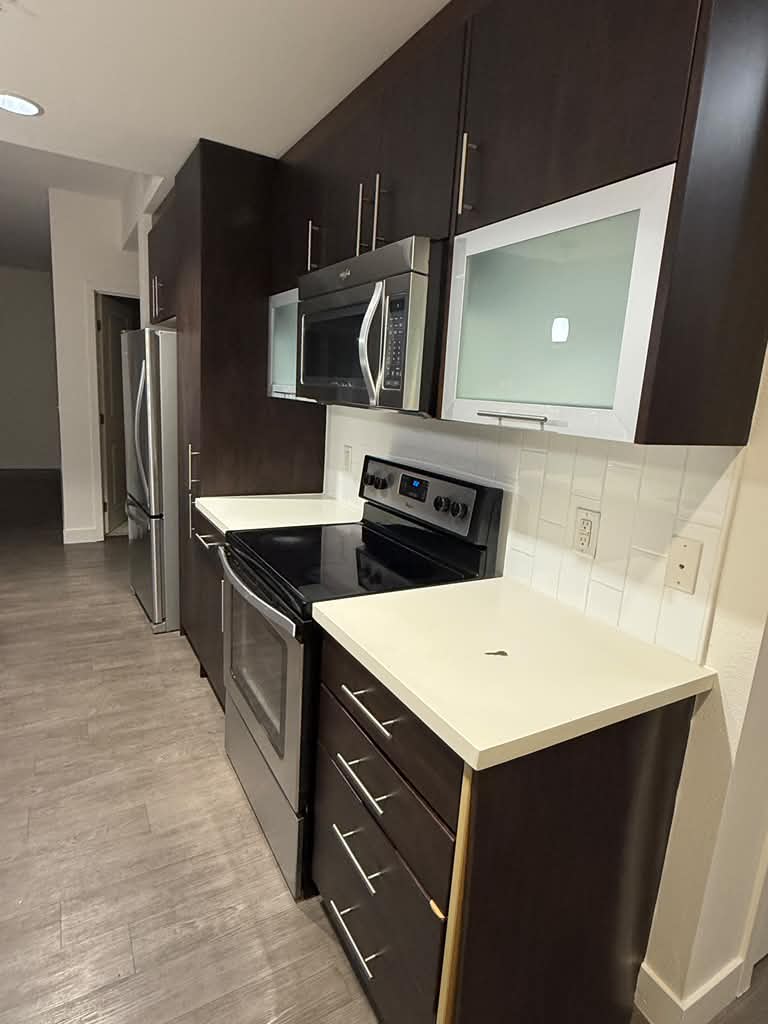 Modern kitchen with clean counters and appliances after remodeling
